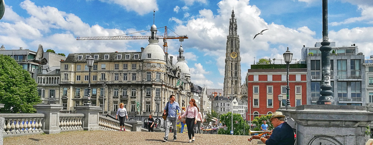 Couple walks on a bridge in Antwerp.